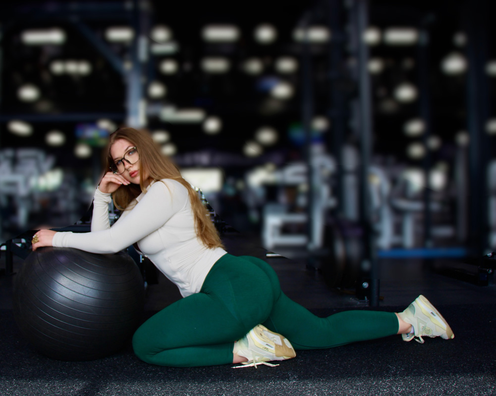Coach is posing in the gym.